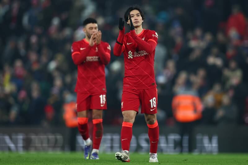 Takumi Minamino of Liverpool applauds fans after the 2-1 FA Cup victory over Norwich at Anfield. Getty