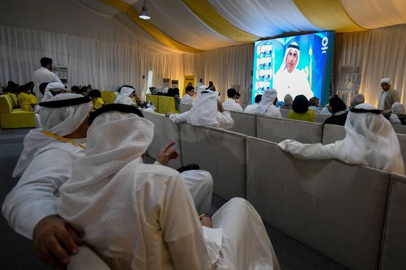 Kuwaitis watch the preliminary results of the parliamentary elections on a screen in Kuwait City. EPA