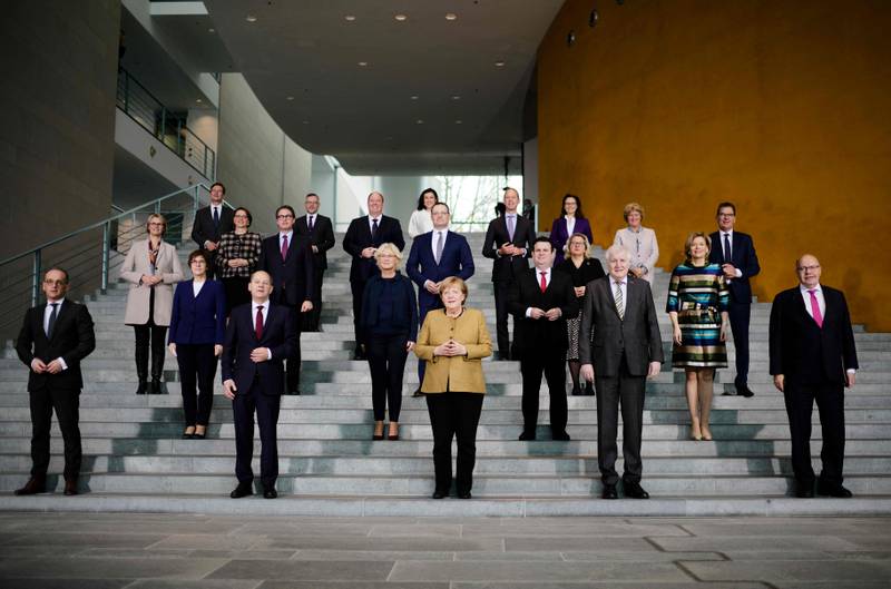 Mrs Merkel poses with ministers and other members of her government after a cabinet meeting in Berlin on November 24, 2021. AFP