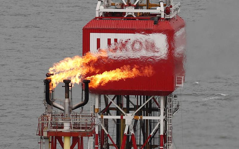 A gas torch is seen next to the Lukoil company sign on an oil platform in the Caspian Sea. Oil prices increased after Russia confirmed oil exports via the Caspian Pipeline Consortium will fall by around a million barrels a day for up to two months as a result of storm damage. Reuters