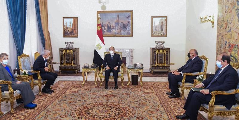 Egyptian President Abdel Fattah El Sisi, centre, meets Mr Lapid. EPA