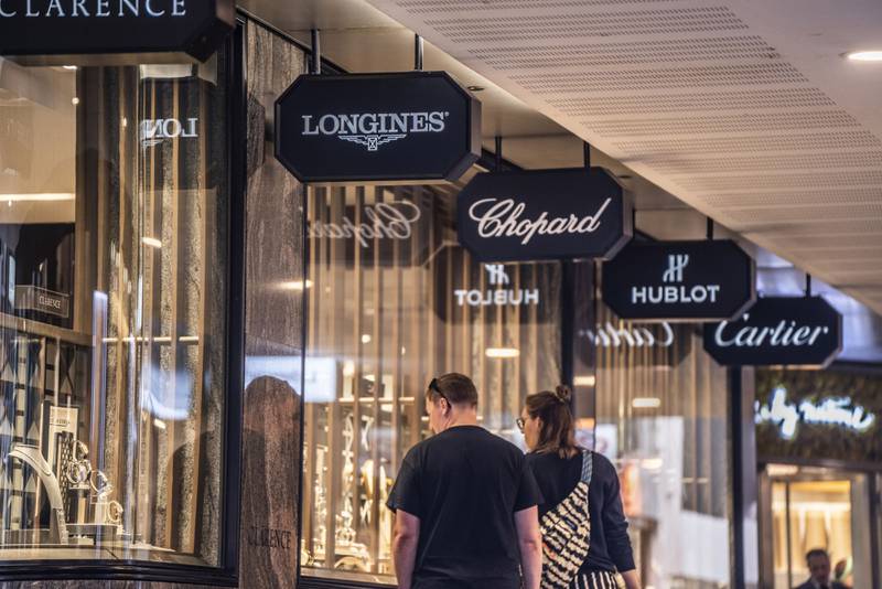 Shoppers browse the window of a luxury watch and jewellery store in Geneva, Switzerland. Demand for luxury watches has been soaring after many cash-flush consumers discovered Swiss brands while stuck at home during the pandemic. Bloomberg