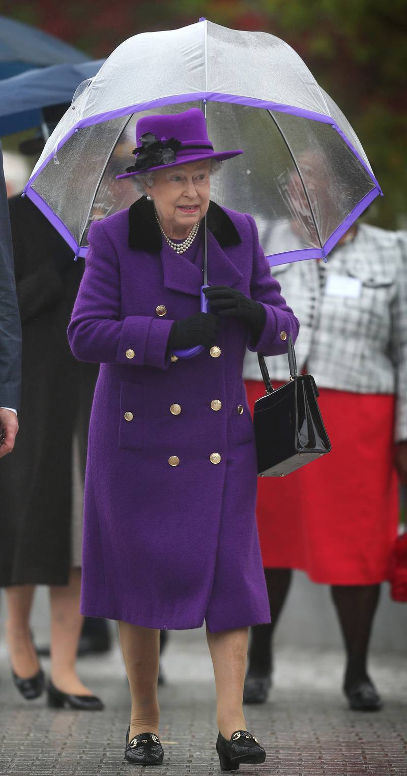 Queen Elizabeth II, wearing purple, attends the opening of the rebuilt Jubilee Gardens on October 25, 2012, in London. Getty Images