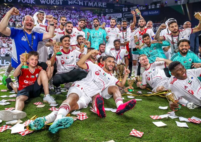 Sharjah players and staff celebrate winning the President’s Cup. Victor Besa / The National