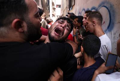 The friend of a young Palestinian killed during the night in the Jabaliya refugee camp in the northern Gaza Strip, is overcome at his funeral in the same camp. AFP