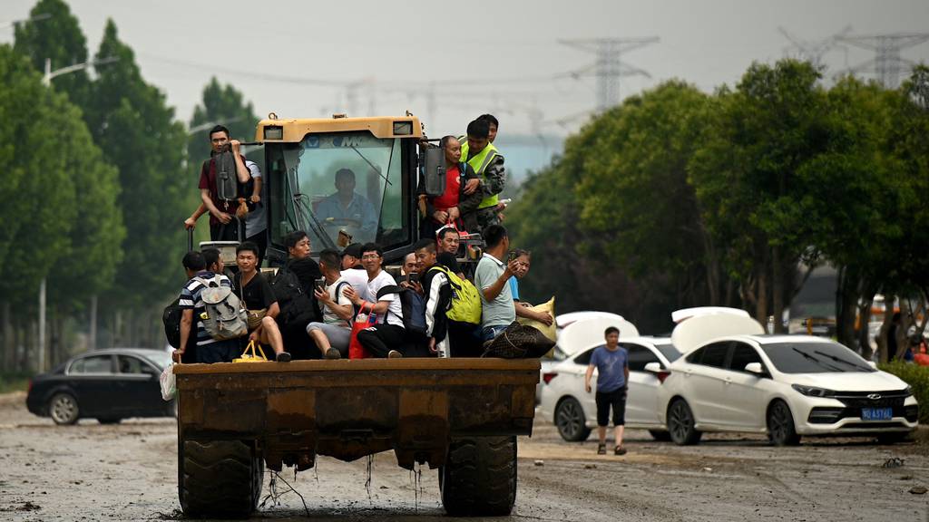 Rescuers use bulldozers to save residents from floods in China