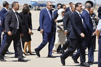 Mr Erdogan, centre, arrives at the Torreon air base in Madrid. AP