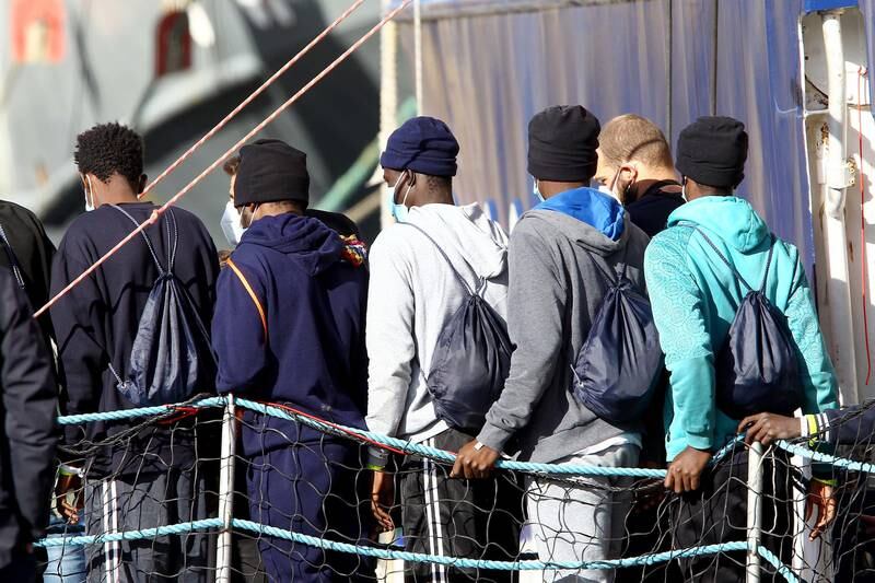 Some of the 261 migrants leave the German aid ship Humanity1 at Bari, Italy, on Sunday. EPA