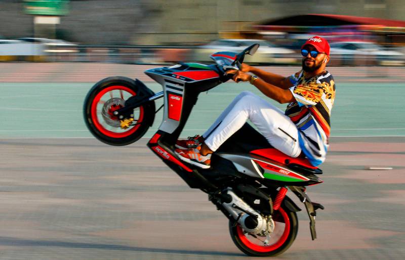 A man performs stunts with a scooter in the Libyan capital Tripoli. AFP