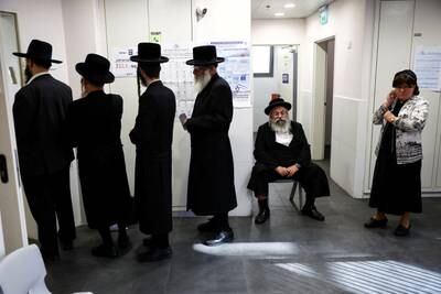 Ultra-Orthodox Jewish Israelis wait to cast their ballots at a polling station in Jerusalem. Reuters