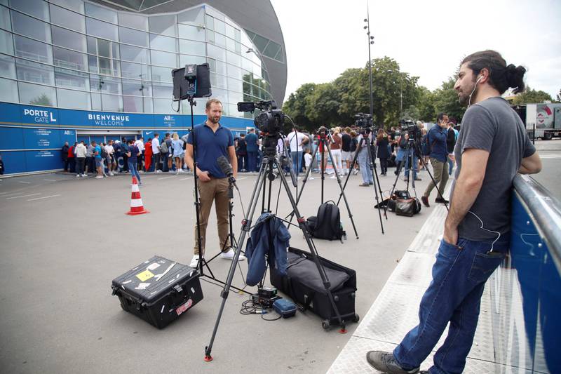Journalists and supporters gather outside PSG's Parc des Princes stadium awaiting the arrival of Lionel Messi.