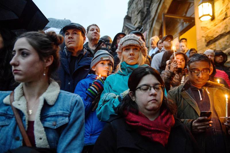 People stand on the stairs of Sixth Presbyterian Church as the crowd spills up the hill and down the street for a vigil blocks from where a shooting occured at the Tree of Life synagogue. AP Photo