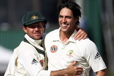 Mitchell Johnson is congratulated by captain Ricky Ponting on the wicket of Ross Taylor during day four at Seddon Park.