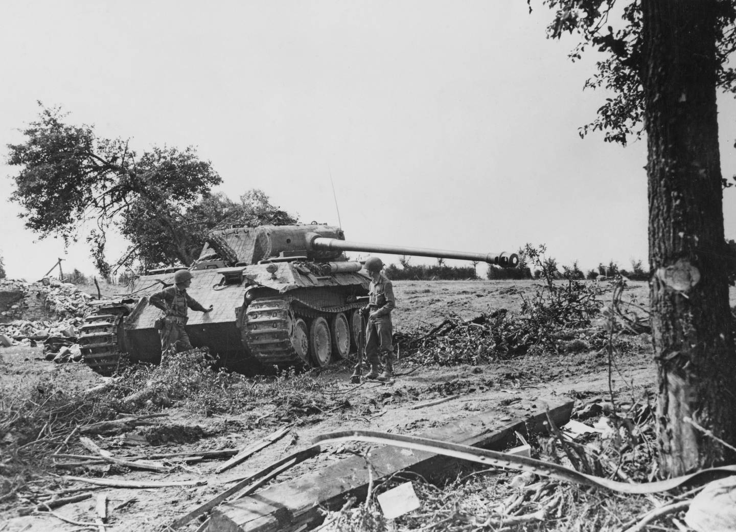 Captain Henry Baushausen and Lieutenant Gardner Colson of the 359th Infantry Regiment, 90th Infantry Division, United States Third Army examine a knocked Panzerkampfwagen V Aus G Panther tank from the 33rd Panzer Regiment, 9th Panzer Division during the Normandy Campaign on 28th August 1944 near the Le Bourg Saint-Leonard region of France. Captain Henry Baushausen would be killed in action on 11th November 1944. US Official Photo EA 34517 (KY) (Photo by Keystone/Hulton Archive/Getty Images).