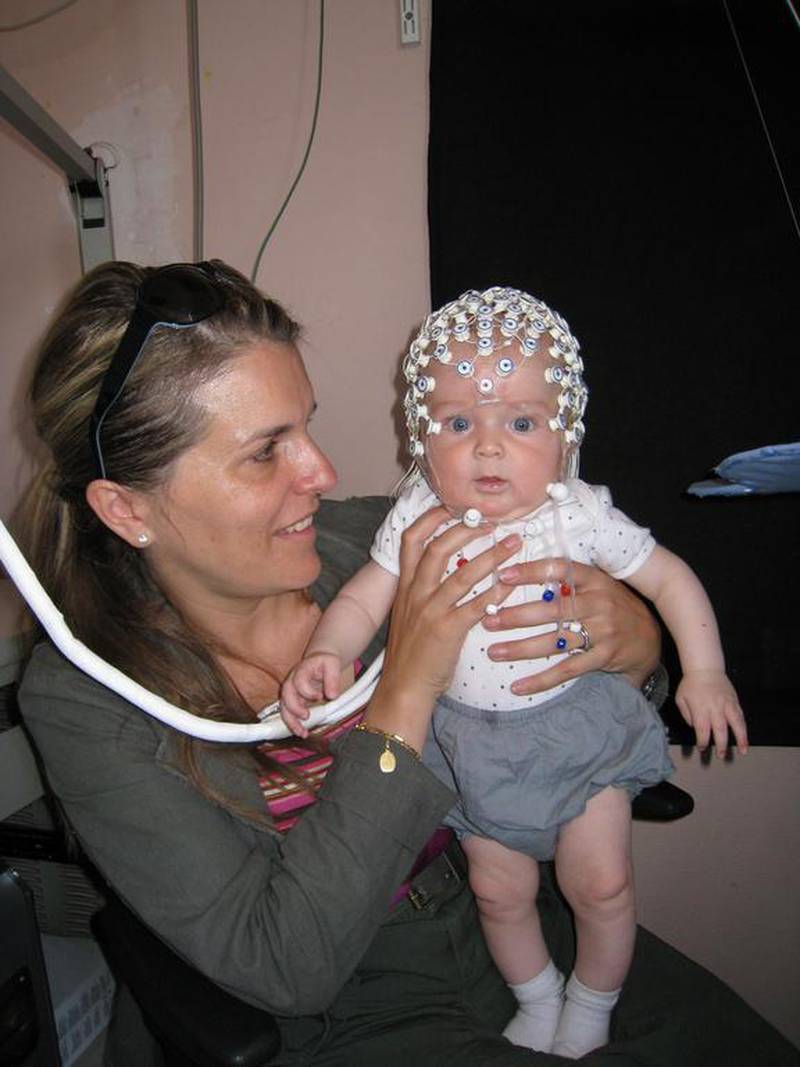 A five-month-old baby is prepared for testing by Prof Sid Kouider’s group at New York University Abu Dhabi. The results suggest that babies are conscious of their surroundings at an earlier stage than initially thought. Courtesy of Sofie Gelskov 

