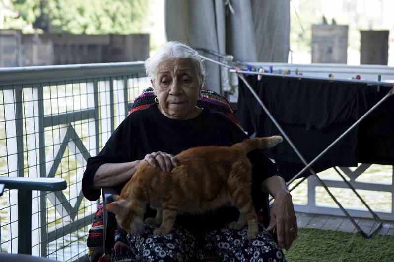 Ikhlas Helmy, an 88-year-old owner of a houseboat in Cairo, Egypt, sits on the veranda on June 27, 2022.  A government push to remove the string of houseboats from Cairo’s Nile banks has dwindled their numbers from a several dozen to just a handful.  Helmy stands to evicted, and the boat moved or demolished.  The tradition of living on the Nile River dates back to the 1800s, and the removal of the boats has drawn criticism in Egypt.  The government says it plans to develop the waterfront.  (AP Photo / Tarek Wagih)