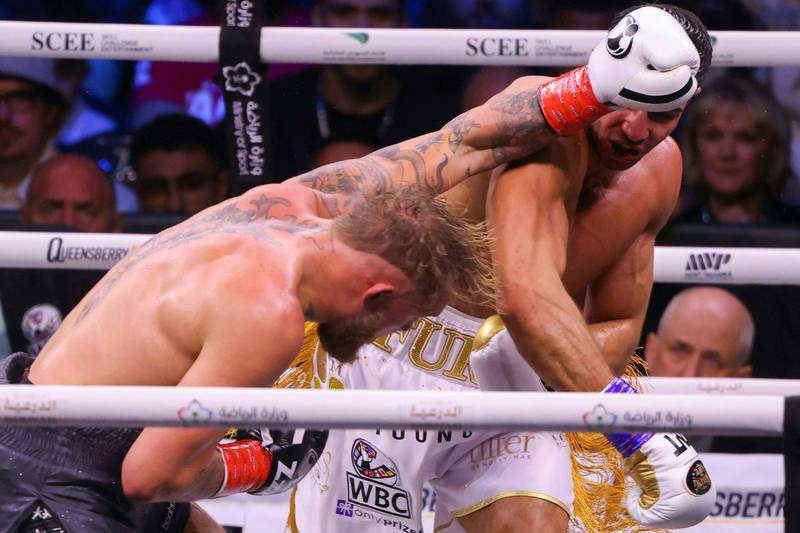 Tommy Fury, right, lands a punch on Jake Paul. AFP