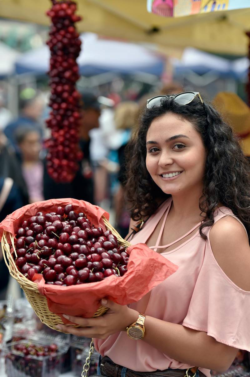 A woman poses as she carries a cherry basket during Cherry Day in the village of Hammana, southeast of Beirut, Lebanon.  EPA