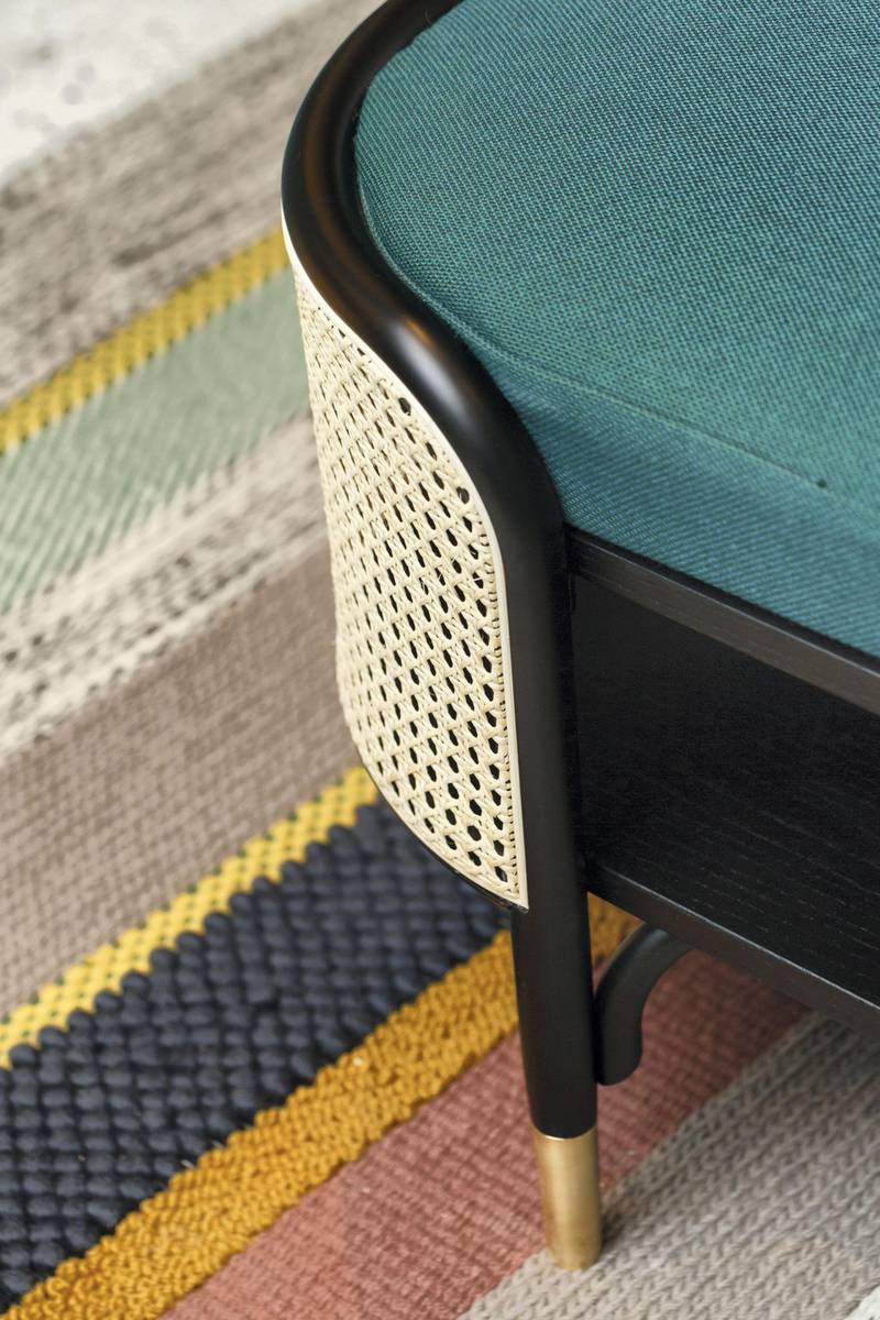 The retro aesthetic extends to the rugs and chairs. Courtesy Ammar Basheir