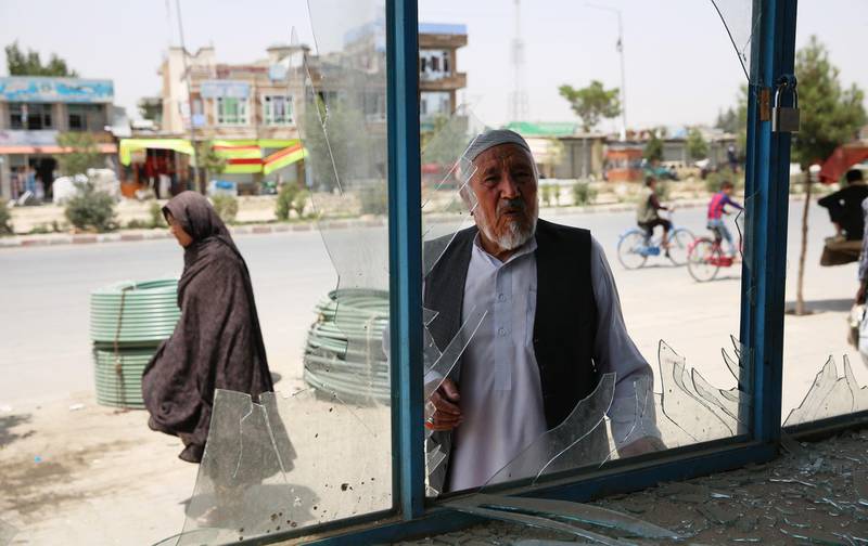 epa07760008 Afghan men clean their broken windows after a truck bomb explosion followed by gun fight targeted a police station in a heavy residential area in the west of Kabul, Afghanistan, 07 August 2019. According to the reports at least 20 people were killed and 100 others wounded.  EPA/JAWAD JALALI