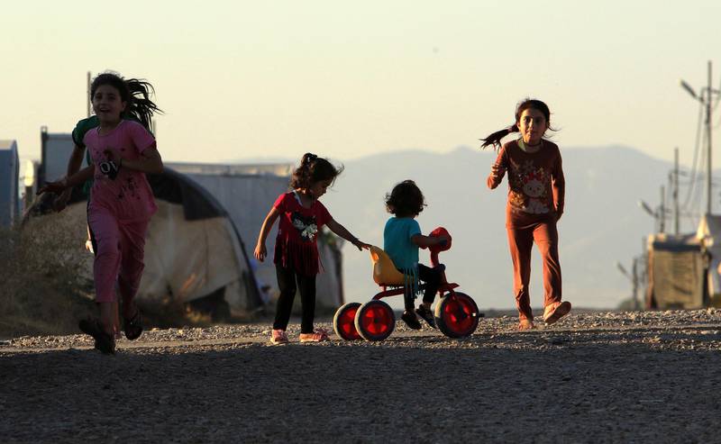 FILE PHOTO: Displaced Iraqi children from the minority Yazidi sect, who fled the Iraqi town of Sinjar, play at the Khanki camp on the outskirts of Dohuk province, July 31, 2019. Picture taken July 31, 2019.  REUTERS/Ari Jalal/File Photo
