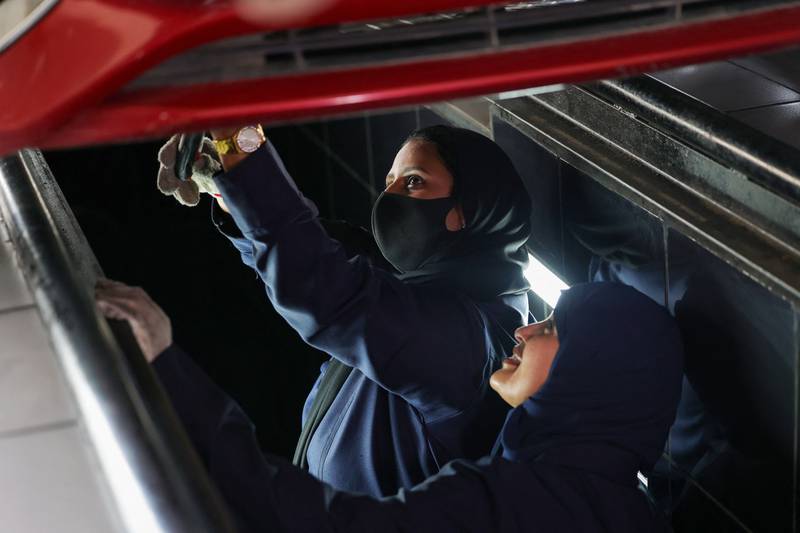 Saudi women Ghada Ahmed, left, and Ola Flimban work on a car at a quick service garage in Jeddah. All photos: AFP