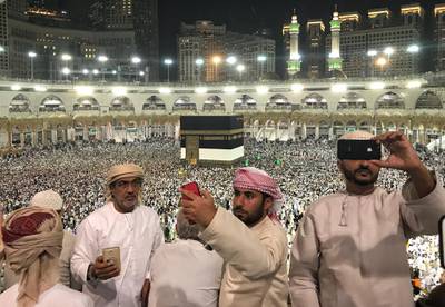 Hajj pilgrims take photos of the holy Kaaba. EPA