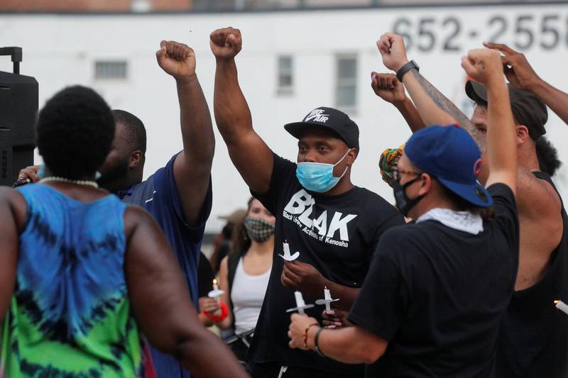 People react while gathering for a vigil, following the police shooting of Jacob Blake, a Black man, in Kenosha, Wisconsin, U.S., August 28, 2020. REUTERS/Brendan McDermid