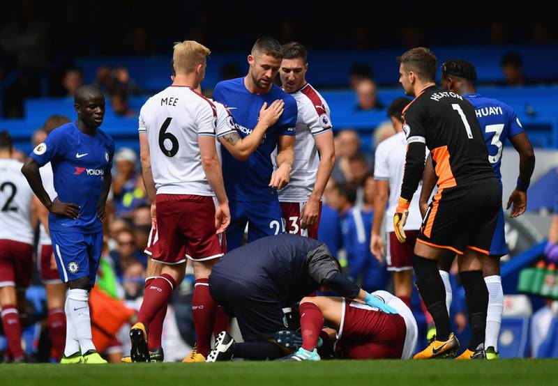 LONDON, ENGLAND - AUGUST 12:  Gary Cahill of Chelsea checks that Steven Defour of Burnle  is okay after fouling him during the Premier League match between Chelsea and Burnley at Stamford Bridge on August 12, 2017 in London, England.  (Photo by Dan Mullan/Getty Images)