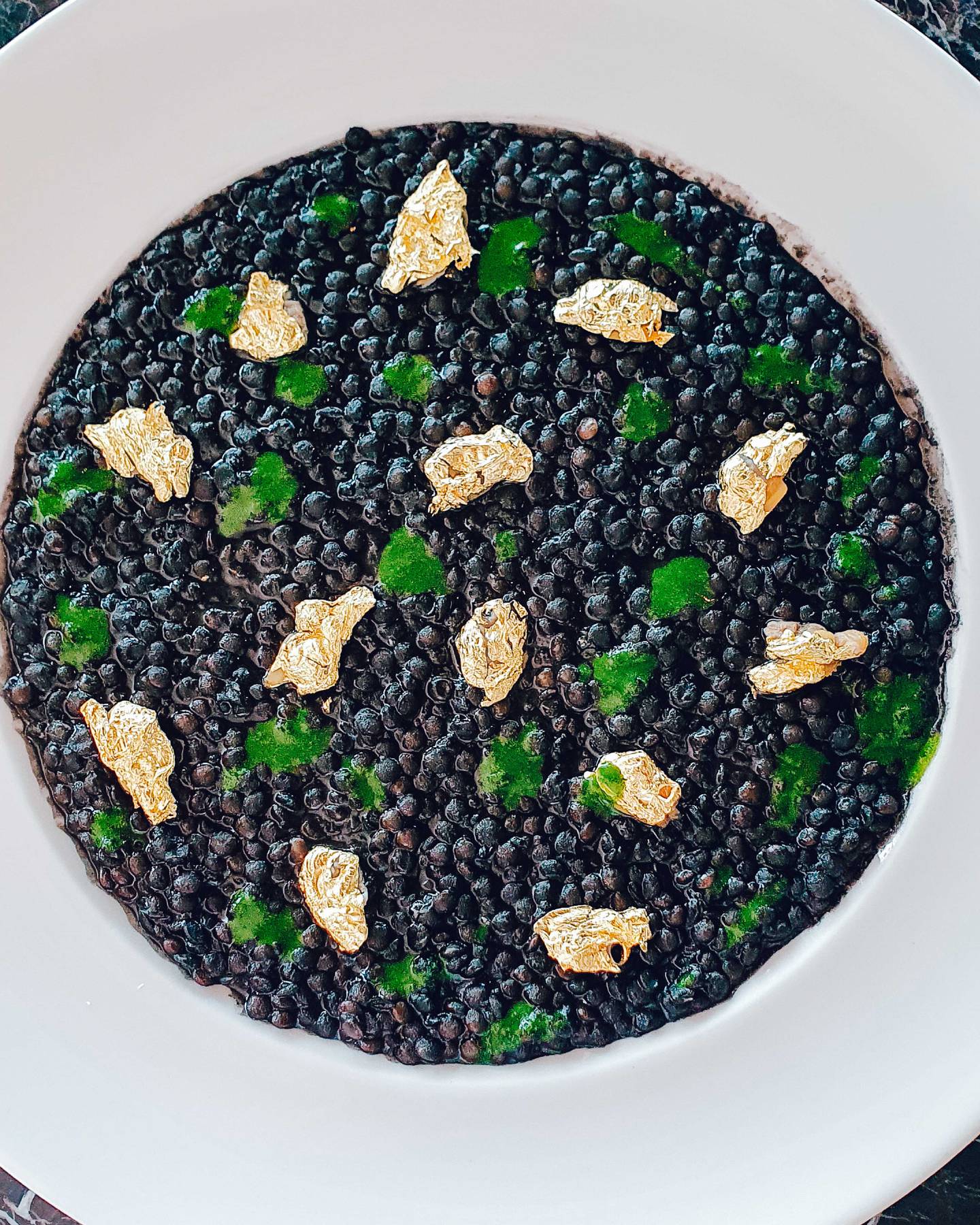 A lentil risotto, garnished with gold, will be served at the exclusive 50-hands chef dinner at Expo 2020. Photo: Jubilee Gastronomy