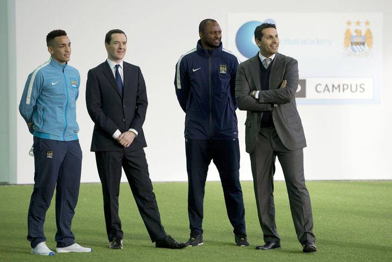Manchester City Under 18 midfielder Kean Bryan, Britain's Chancellor of the Exchequer George Osborne, Manchester City reserves squad manager Patrick Vieira and chairman Khaldoon Al Mubarak observe the new City Football Academy in 2014. AFP