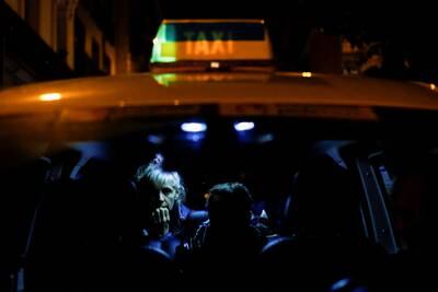 A Ukrainian woman and her family in a taxi displaying the colours of the Ukrainian flag upon arriving in Madrid with a group of Spanish taxi drivers who drove to Poland to support the mass evacuation of refugees. Reuters