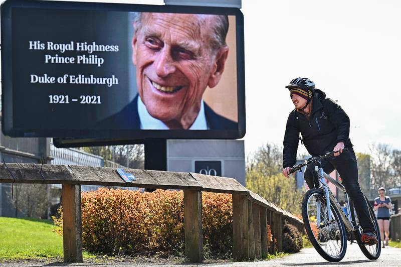 A cyclist rides past a digital display commemorating Prince Philip, in Glasgow, Scotland. Getty Images