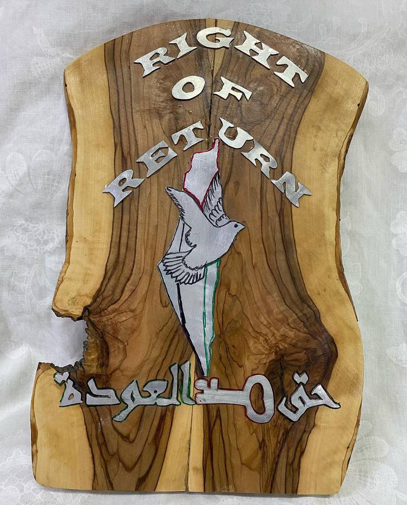Proclaiming the "right of return", this olive wood and gas canister metal sign   speaks of the longing by residents in the Aida refugee camp to return to their lands. Photo: Art48House/Instagram