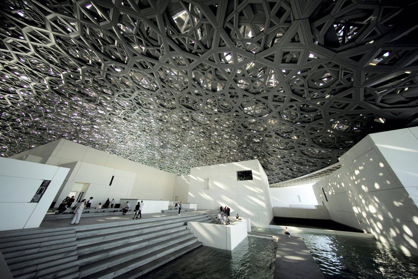 FILE PHOTO: Visitors look at the dome hall design of the Louvre Abu Dhabi Museum in Abu Dhabi, United Arab Emirates, December 25, 2018. Picture taken December 25, 2018. REUTERS/Hamad I Mohammed/File Photo