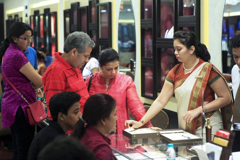 Customers buy gold jewellery during Dhanteras, which marks the beginning of the five-day Hindu Diwali festival and is traditionally a popular day for Indians to buy gold. Subhash Sharma for The National