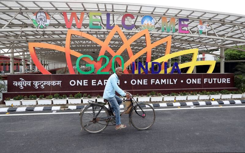 Locals pass by the G20 logo near the Bharat Mandapam at ITPO Convention Centre in New Delhi last month. EPA
