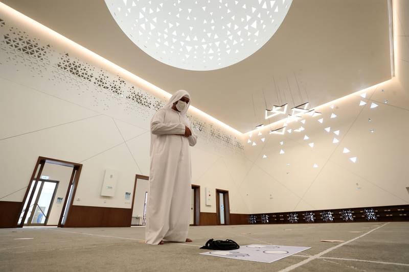 Ali Al Mulla prays in the main hall of the mosque.