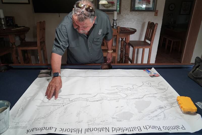 Mr Lerma studies a map of his family property, which has been in his family since 1861.