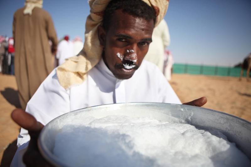 United Arab Emirates - Madinat Zayed - December 13th, 2010:  A camel farmer drinks fresh camil milk from a bowl after a milking competition at the Camel Festival in Madinat Zayed.  (Galen Clarke/The National)