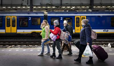 Ukrainian refugees are helped by volunteers upon their arrival at Amsterdam Central station by train from Berlin. AFP