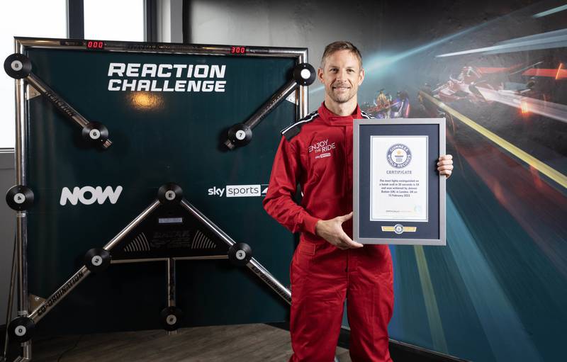 Jenson Button is presented with a Guinness World Records certificate. PA
