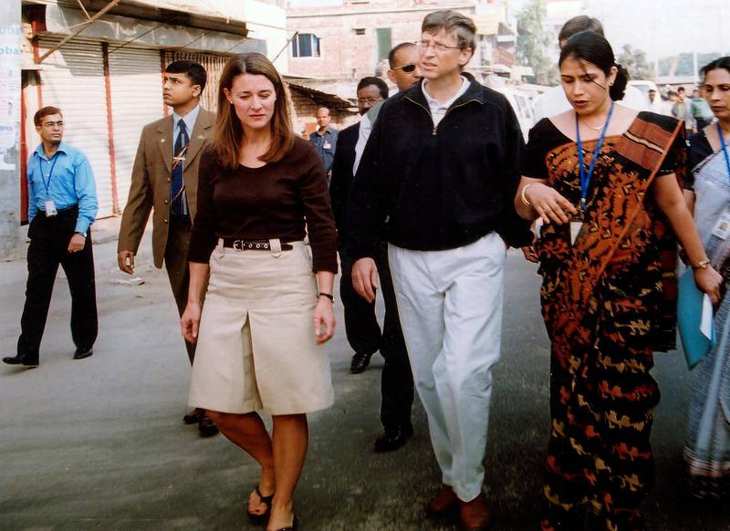 Bill Gates and his wife Melinda, left, walk on a street in Dhaka, Bangladesh, Dec. 5, 2005. AP Photo
