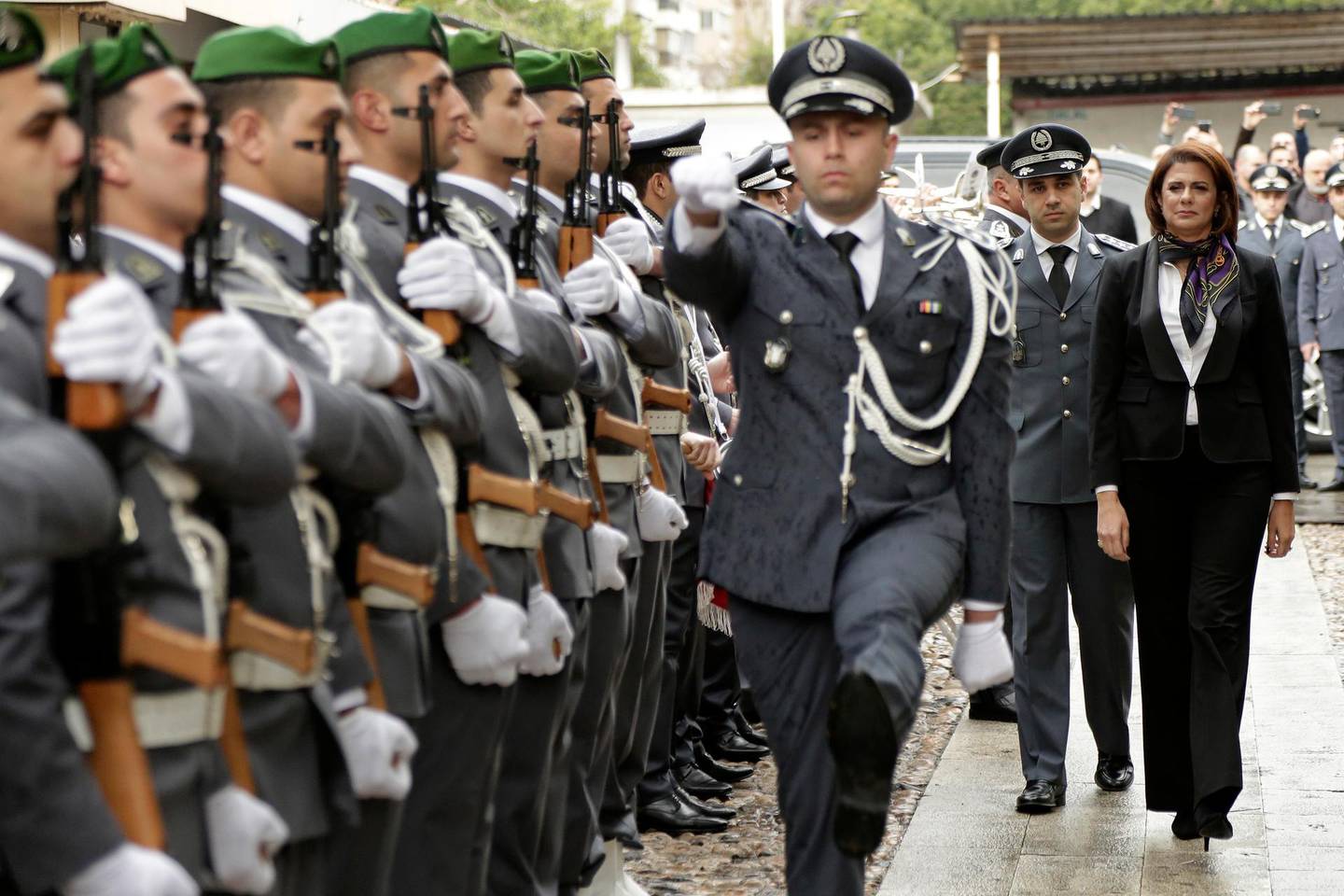 Newly appointed Interior Minister Raya El Hassan, right, reviews an honor guard during a ceremony held on her first day at the interior ministry, in Beirut, Lebanon, Wednesday, Feb. 6, 2019. El Hassan is one of four women in the new 30-member Cabinet, becoming the country and the Arab world's first female official in charge of the powerful security agencies. (AP Photo/Hassan Ammar)