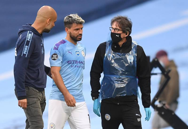 Manchester City manager Pep Guardiola talks to his forward Sergio Aguero as he walks off injured. EPA