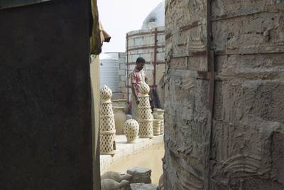After moulding, the craftsmen cut designs into the pieces, or stack them straight into one of two kilns to be dried for five days. Mona Al-Marzooqi/ The National 


