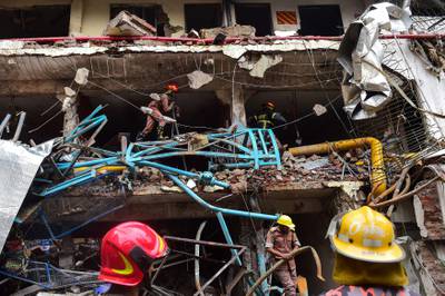 Bangladeshi firefighters take part in a search and rescue operation at a destroyed garment factory in Gazipur on July 4, 2017, after a boiler explosion at the complex on the outskirts of Dhaka.
At least 10 people were killed and three remained missing on the second day of a boiler explosion incident at a garment factory in Bangladesh, officials said Tuesday. / AFP PHOTO / Munir UZ ZAMAN