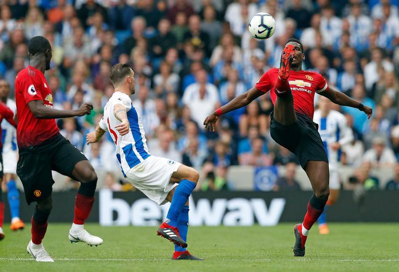 Paul Pogba is challenged by Brighton mifielder Pascal Gross. AP Photo