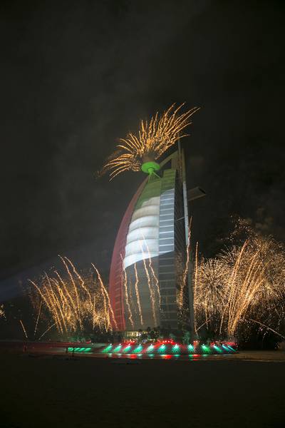 Burj al Arab, one of the iconic Dubai buildings, lights up in the light of fireworks and a light show. Silvia Razgova / The National