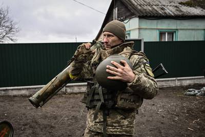 A Ukrainian soldier holds an anti-tank launcher north-east of Kyiv. AFP